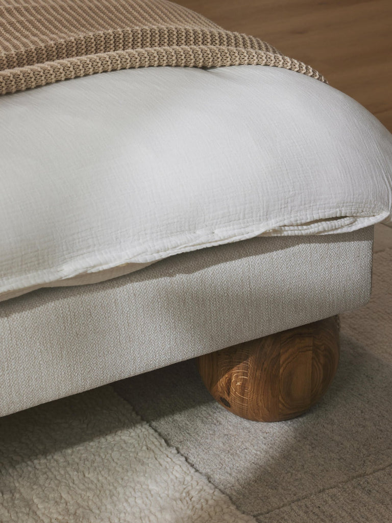 Lit matelassé avec pieds boules en bois Rena