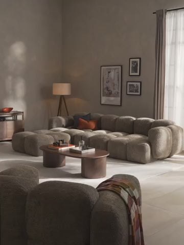 Canapé modulable 4 places en peluche-bouclette avec pouf Tayla